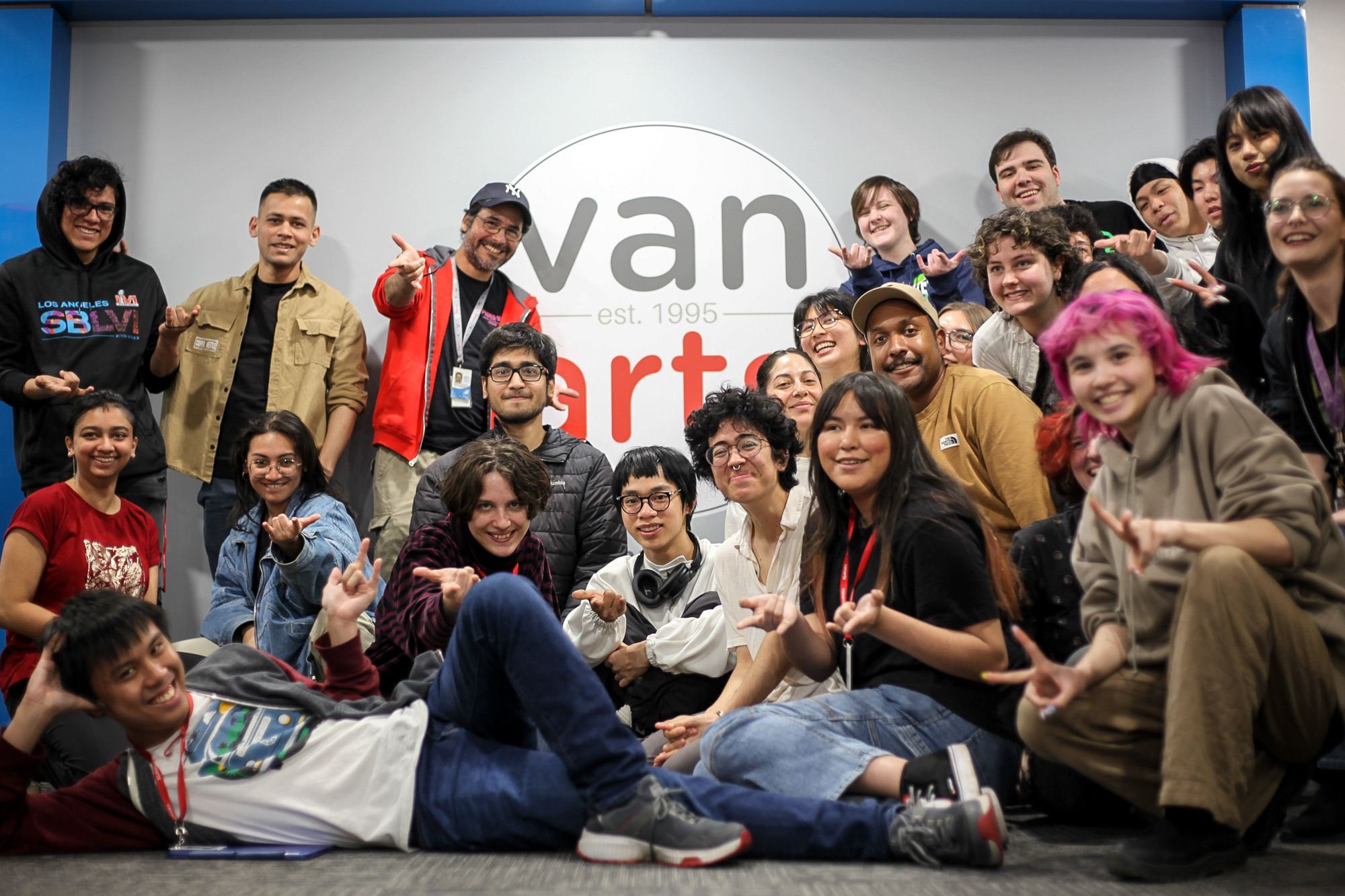 Sam Rico posing for a group picture with VanArts Character Animation students